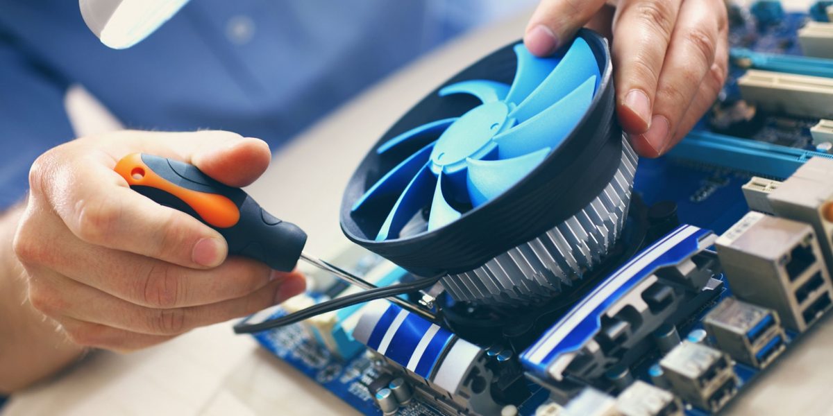Technician assembling a computer cooling fan.